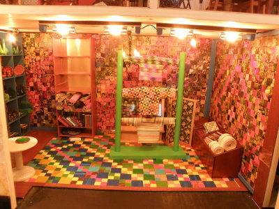 The floor tiles are made of Fimo clay. A photo of the floor is used as the shop's brand on shopping bags and wrap on the yarn.